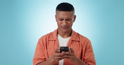 Phone, typing and confused man in studio network on social media, mobile app or the internet