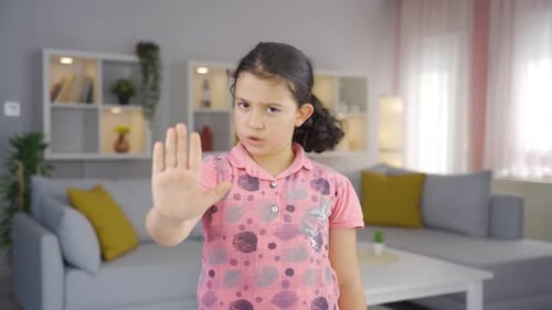 Young Girl Holds Hand Up To Say Stop