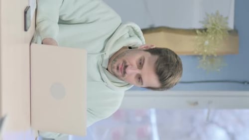 Man Working on Laptop Computer at Home