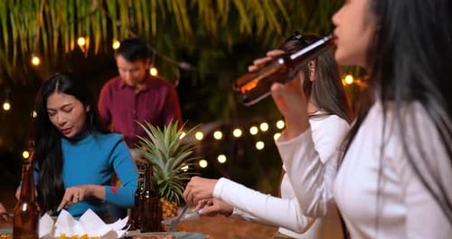 Friends Enjoying Food and Drinks at Night