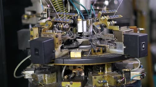 Close-up parts of the with threads producing garments (socks), the Production process in a garment