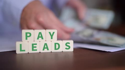 Concept of paying for leads as a strategy. Selective focus with money on the background.