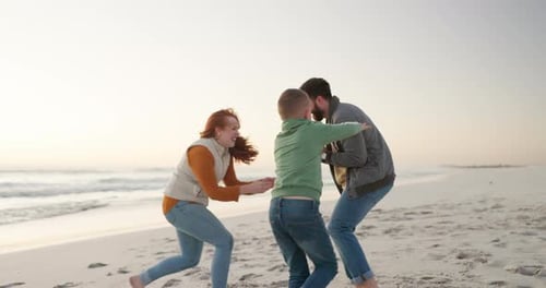 Family, children and playing at beach for fun or bonding with energy for activity on holiday