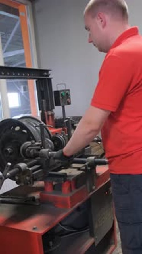 A Mechanic Repairs an Uneven Chassis in a Car Car Service Vertical Video