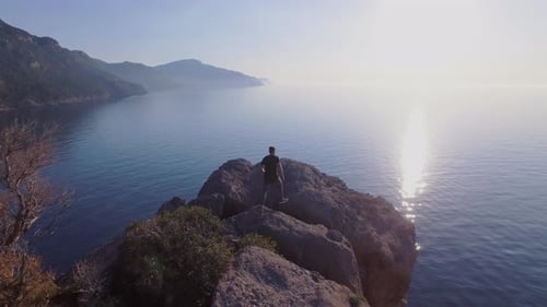 Man walking on cliffs - Hiking in the mountains - Enjoying view of the landscape at the Mediterranea
