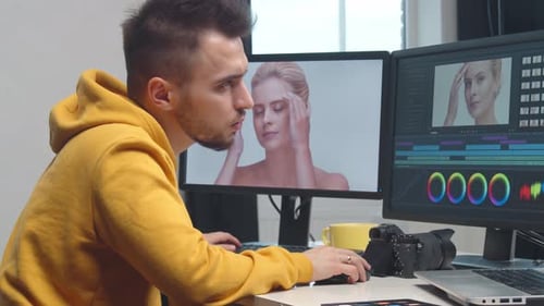 Freelance Videographer Colorist Editing Footage Using Professional Software Monitor and Montage