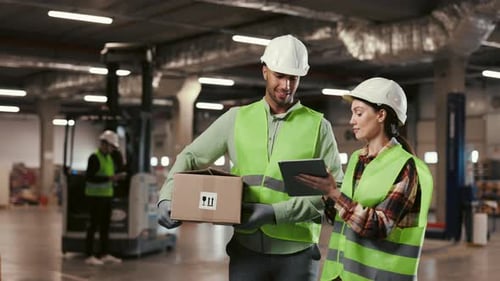 Warehouse Workers Collaborating with Tablet and Box