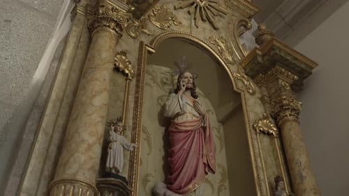 grand, gilded church altar displays sacred statues, including Jesus Christ