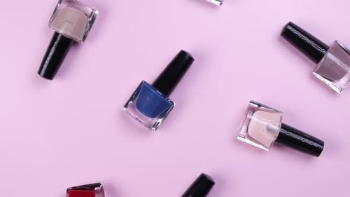 Assorted Nail Polish Bottles on a Pink Surface