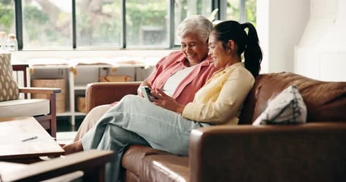 Adult Woman and Senior Woman Using a Mobile Phone