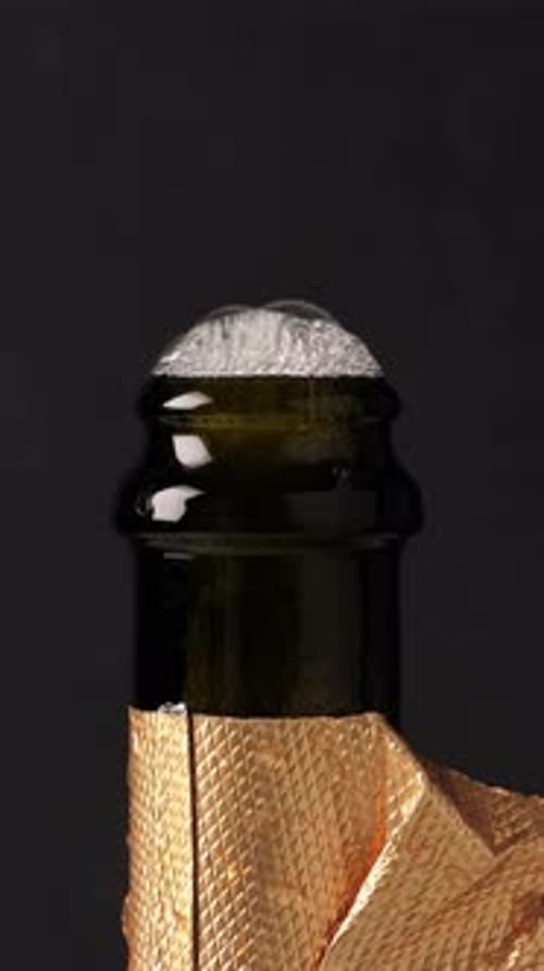 Opening Champagne Bottle with Splashing on Black Background New Year Celebration Vertical