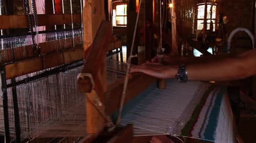 Traditional Weaver Using Loom to Create Textile