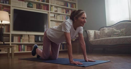 Mature Woman Doing Stretching Exercises at Home