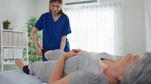 Woman Getting Leg Massage from Physical Therapist Indoors
