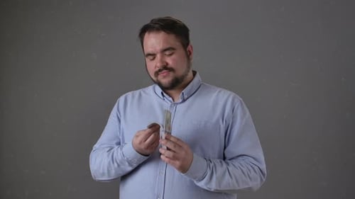 Man Counting Money with Focused Expression Alone
