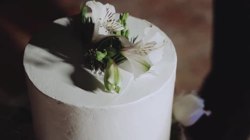 Elegant White Wedding Cake Decorated with Flowers