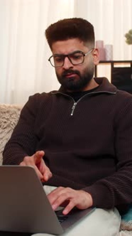 Man Working on Laptop Computer at Home