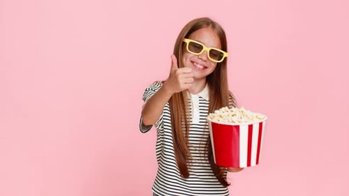 Child Girl Kid Happily Eating Popcorn While Watching Funny Cartoon Laughing and Smiling Cheerfully