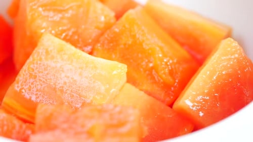 Slice of Papaya on White Plate