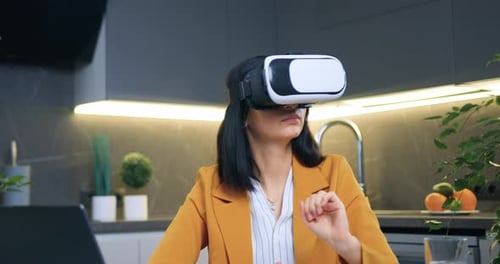 Woman at Kitchen Counter Wears VR Headset