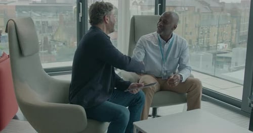 Business Meeting in Modern Office Building with Tablet