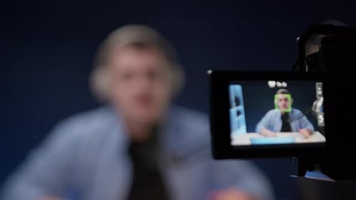 Blogger Sits in His Studio Say Hello and Tells Story to Camera Host of His Own Program on Video