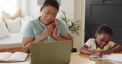 Woman Works from Home While Child Colors