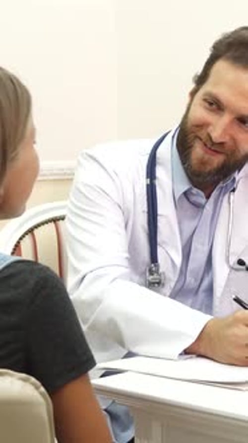 Doctor talking with child patient in a clinic