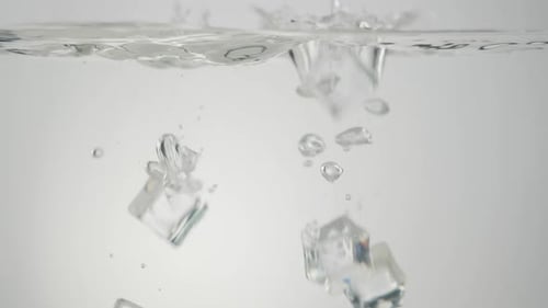 Ice Cubes Dropping Into Clear Water