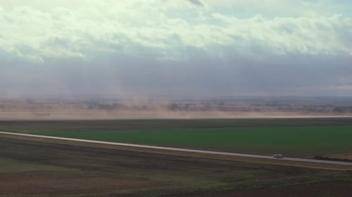 Sweeping View of Dusty Highway Under Stormy Skies in Oklahoma, USA