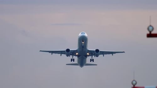 Commercial Airplane Takes Off Into Cloudy Sky