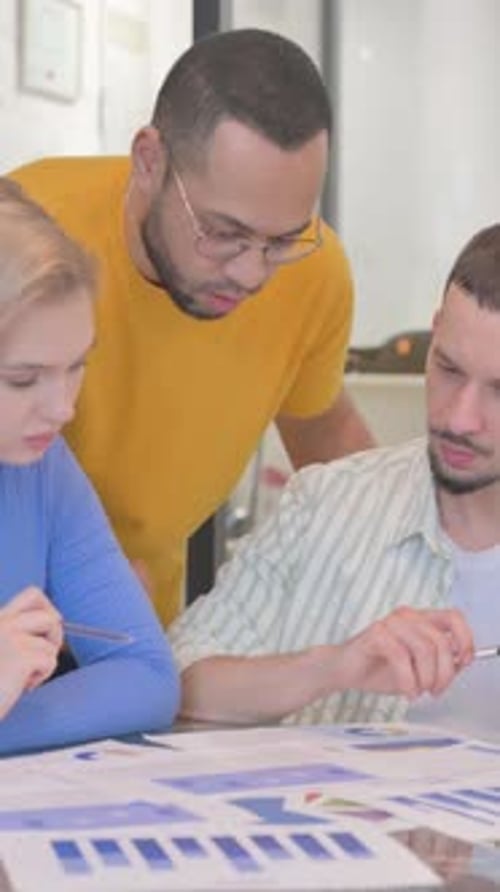 Team Analyzes Business Data in an Office Meeting