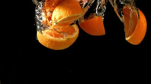 Orange Slices Fall Under Water Filmed is Slow Motion 1000 Fps