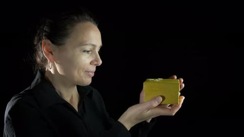 Woman Receives Gift with Glowing Light Inside