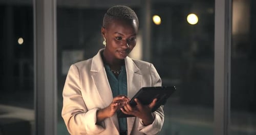 Night, business or woman with tablet in office, reading online feedback or edit investment proposal