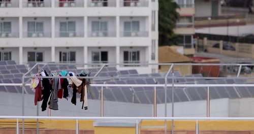 Clothes Hanging on Rooftop Clothesline on Windy Day