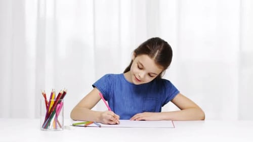 Girl Drawing with Colored Pencils at White Table