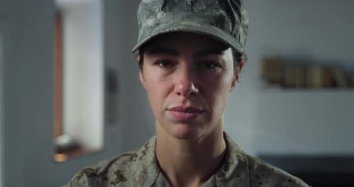 Close Up Portrait of Young Female Patriotic Soldier Standing in Her Home Looking at the Camera Then