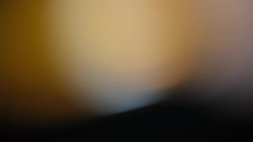 Abstract Shimmering Dark Gold Hue Morphing Background