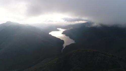 Majestic River in Valley Under Dramatic Sky
