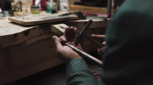 Jeweler Hammering a Ring
