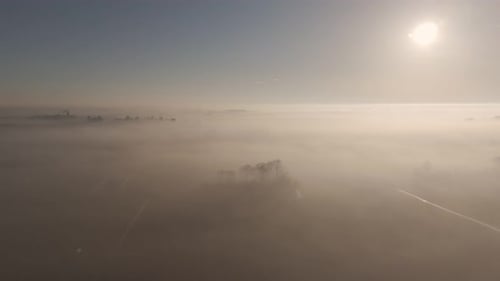 Above the Clouds: Aerial View of Friesland Farmland in Morning Mist