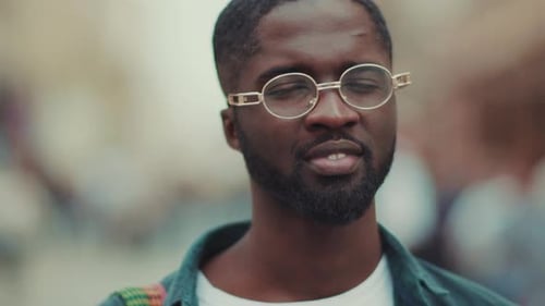 Charming Young African American with Glasses Look at Camera Smile Feel Happy Standing in City Face