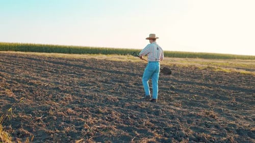 Farmer Going Along Field with Ground Male Worker Working at Summer Time Concept of Agricultural