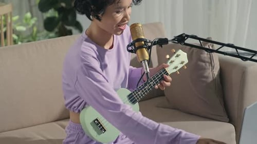 Gen Z Girl Recording Song with Ukulele at Home Music Studio