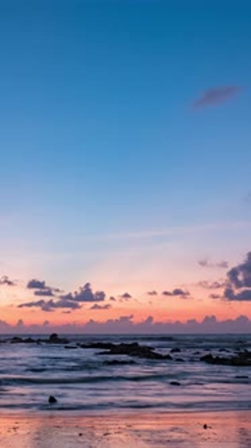 Twilight and dawn sky with cumulus cloud vertical time lapse in an evening at the ocean.