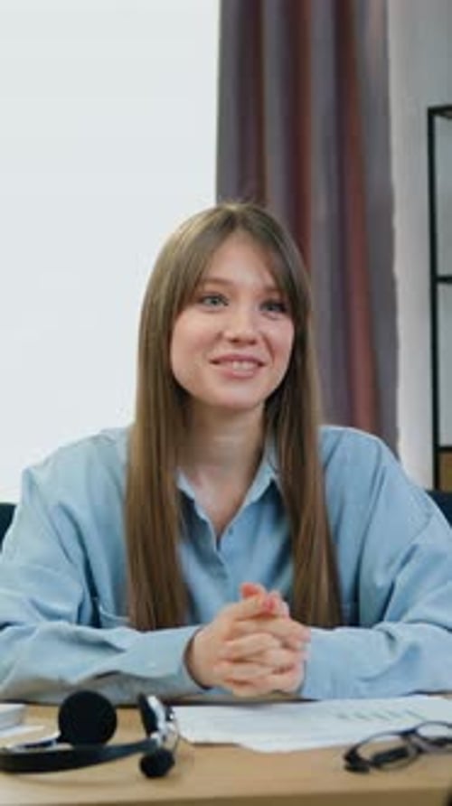 Woman Talking at Desk in Home Office