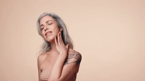 Mature Woman Posing with Gray Hair and Tattoo