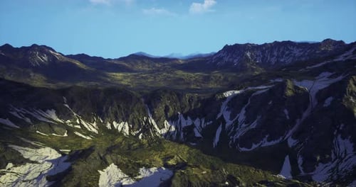 Vast Mountain Landscape Featuring Green Valleys and Snowy Peaks in Daylight