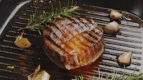 Succulent Steak Garnished with Garlic and Rosemary